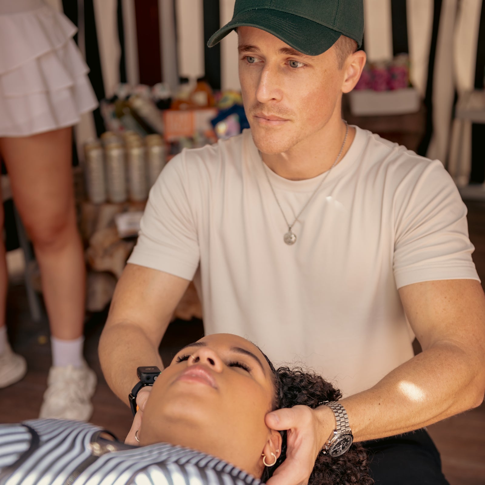 A chiropractor working with an attendee at a past Pups N Chill wellness event