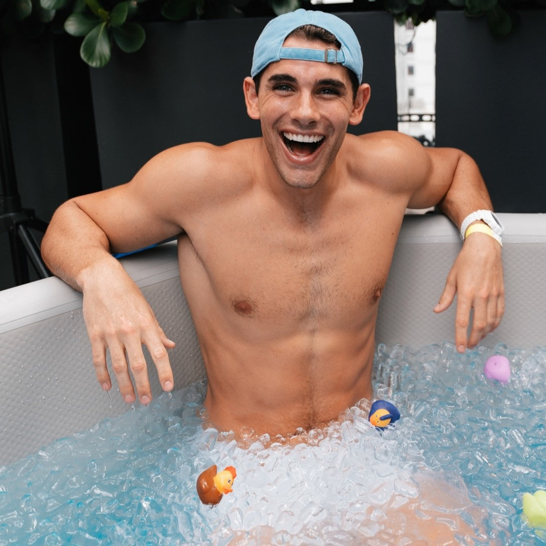An attendee enjoying a community cold plunge at Pups N Chill